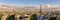 Panoramic summer view of Paris rooftops at sunset with the Eiffel Tower