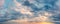 Panoramic sundown sky. Overcast clouds in pastel colors. Only the sky
