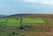 Panoramic sunlit pennine landscape with small valleys between rolling hills with typical yorkshire dales stone walls and farmhou