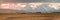 Panoramic sunrise of Wyoming ranch with Grand Teton in the Background