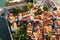 Panoramic sunset aerial drone view of ancient city of Budva, Montenegro. Old medieval town with red roofs. Picturesque Kotor bay,
