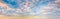 Panoramic sunset sky. Overcast clouds in pastel colors. Only the sky