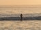 Panoramic sunset view of surfer riding a wave at Huanchaco beach pacific ocean sea Trujillo Peru South America