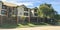 Panoramic three stories and multiple units apartment complex near street suburbs Dallas, Texas