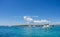Panoramic of a turquoise beach in the Balearic island with sailboats and yacht in the water