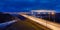 Panoramic twilight view of the bridge with traffic light trails