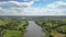 Panoramic video from drone above countryside in a summer cloudy day.