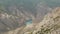 Panoramic view from above, Grand Sulak canyon in The Republic of Dagestan, village Dubki, Russia. Mountain River in