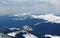 Panoramic view above the mountain ridges covered by snow