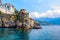 Panoramic view, aerial skyline of small haven of Amalfi village with tiny beach and colorful houses located on rock. Tops of