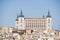 panoramic view of the Alcazar of Toledo and part of the surrounding houses one sunny and torrid afternoon