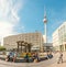 Panoramic view of Alexanderplatz square with famous TV tower and crowds of people