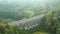 Panoramic view of arch bridge or historic aqueduct in the forest among trees.