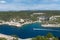 Panoramic view of the Bay and cliffs from above. The yacht sails in the center. In the background mountains and sky