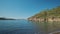 panoramic view of beautiful calm turquoise sea water at wild solitary pebble beach with cliffs at coast of mediterranean