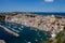 Panoramic view of the beautiful Procida in sunny day. Colored houses in Marina Corticella, clear blue sky and blue sea