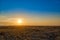 Panoramic view: beautiful spring landscape: spring huge great steppe wakes up from winter sleep - snow and ice just melted, sunset