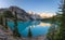 Panoramic view of beautiful sunrise over turquoise waters of the Moraine Lake