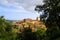 Panoramic view beyond trees on French mediterranean medieval village with church tower on hill top - Ramatuelle, Cote dÂ´Azur,