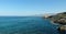 Panoramic view of the blue sea, rocky coast, clear sky