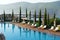 Panoramic View of Bodrum Beach, Aegean sea, traditional hotel view with sunbeds, slim cypress, yachts in Bodrum town