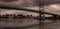 Panoramic view of Brooklyn Bridge against skyscrapers of New York on a gloomy day