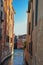 Panoramic view of buildings on a canal that ends on another canal at the sunset in Venice.