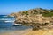 Panoramic view of Capo Figari cape rocks and seashore of Spiaggia di Cala Spada beach at the Tyrrhenian Sea coast in Golfo Aranci