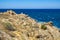 Panoramic view of Capo Figari cape rocks and seashore of Spiaggia di Cala Spada beach at the Tyrrhenian Sea coast in Golfo Aranci