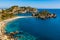 Panoramic view of Capo Taormina cape with Isola Bella island on Ionian sea shore in Messina region of Sicily in Italy