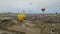 Panoramic view of Cappadocia during a balloon flight. A large number of balloons at dawn in the territory of Cappadocia. Cloudy