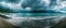 A panoramic view captures the tempestuous beauty of a stormy sea against a rugged coastline, where the drama of nature