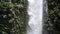 Panoramic view of cascading mountain waterfall. Close up view in slow motion.
