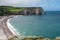 Panoramic view on chalk cliffs and Porte d`Aval arch in Etretat, Normandy, France. Tourists destination