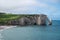 Panoramic view on chalk cliffs and Porte d`Aval arch in Etretat, Normandy, France. Tourists destination