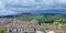 Panoramic view of Chinchon village, Community of Madrid, Castille-La Mancha, Spain. Dramatic stormy sky over suburban scenery