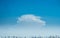 Panoramic view of city background blue sky with white huge single floating clouds against blue sky