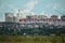 Panoramic view of the city buildings: high-rise red buildings and low-rise houses among the greenery