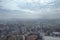 Panoramic view of a city with the sky full of clouds.