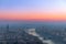 Panoramic view of the city of Verona and the Adige river with bridges covered with the evening mist colored by the setting sun.