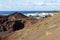 Panoramic view on the coastline of El Golfo with red and black colored volcanic rock formations and lava fields on canary island