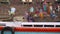 Panoramic view of colorful boat with Varanasi ghat in background.