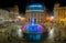 Panoramic view of the colorful fountain of De Ferrari square by night in Genoa, Italy.