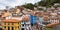 Panoramic view of the colorful houses located on the hill by the sea in the fishing village of Cudillero, Asturias.