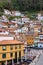 Panoramic view of the colorful houses located on the hill by the sea in the fishing village of Cudillero, Asturias.