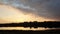 Panoramic view of colorful sunset clouds over the lake. Idyllic autumn evening, natural scene near a countryside pond