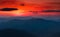 Panoramic view of colorful sunset in the mountains. Dramatic overcast sky.