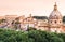 Panoramic view of the Colosseum and rooftops at sunset, Rome, Italy