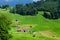 Panoramic view of countryside, green alpine meadows and mountains