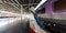 Panoramic view of couple holding hands in train station. In love young Asian woman holding boyfriend hands follow her at train